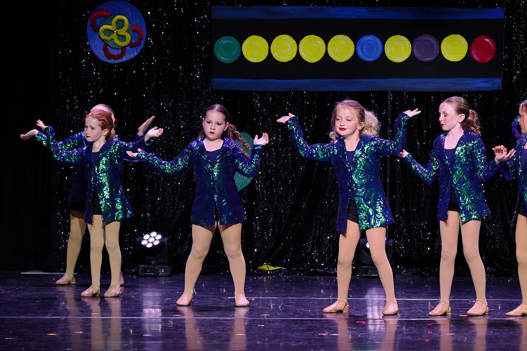 Jazz dancers in green sequin jackets at an Ignite Your Flare recital